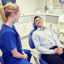 man talking to his implant dentist in Loveland 