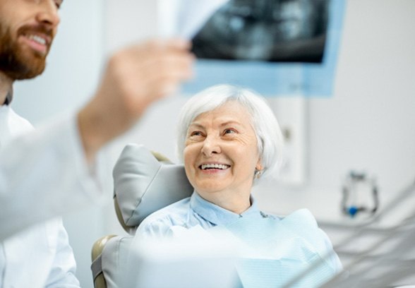 patient smiling while talking to dentist 