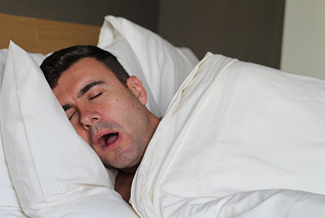 Close-up of man with sleep apnea in Loveland, OH sleeping in bed