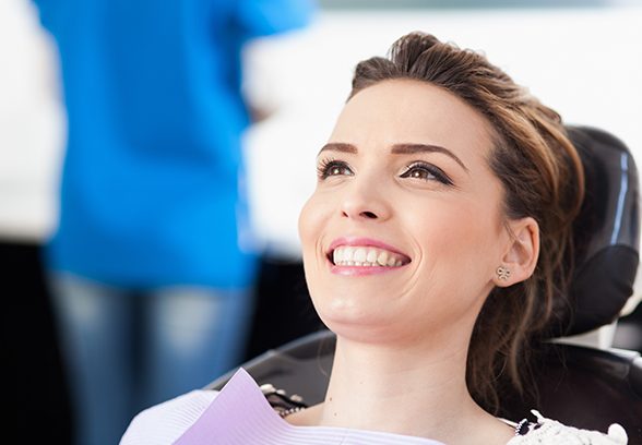 Woman smiling during preventive dentistry exam