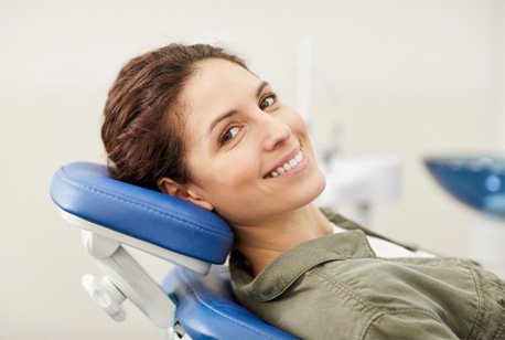 Woman leaning back in chair and smiling after cosmetic dentistry in Loveland, OH