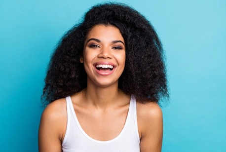 smiling woman against turquoise background