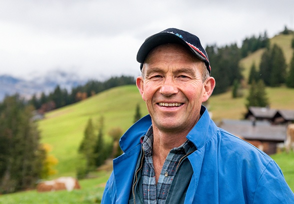 Older man with dentures smiling outdoors