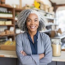 older woman smiling and standing in a store