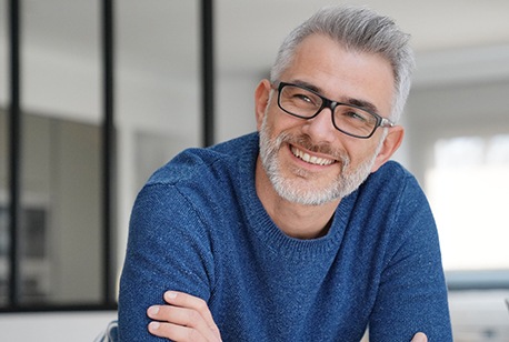 closeup of man smiling arms crossed