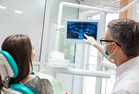 dentist showing a patient their dental X-rays