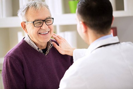 dentist putting his hand on a patient’s shoulder