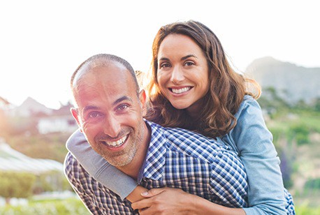 happy couple holding each other outside