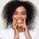 a woman flossing to care for her dental implants