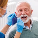 a dentist checking a patient’s dental implants in Loveland