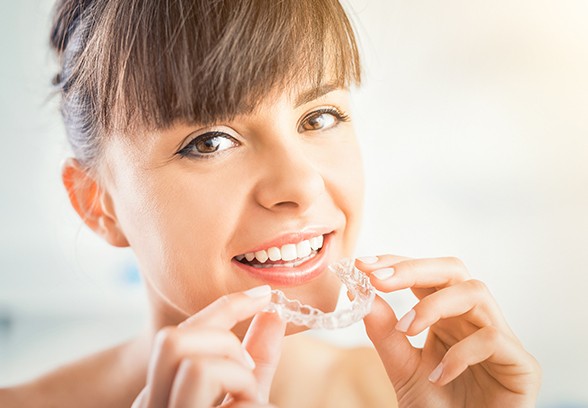 Woman placing clear alignment tray