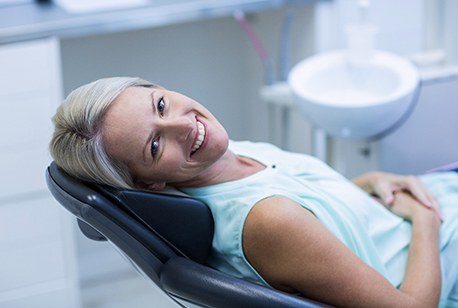 Female patient laying back and smiling after TMJ treatment in Loveland, OH