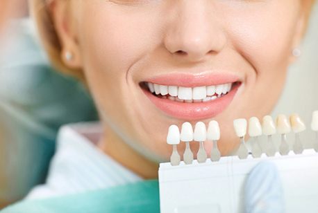 Woman getting veneers in Loveland color-matched