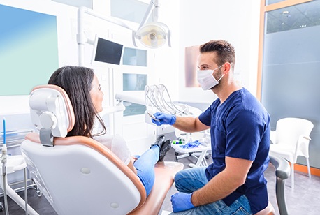 Dentist and patient talking in dental office