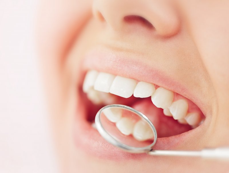 dentist inspecting patient’s dental filling