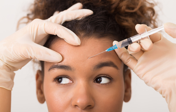 woman getting botox injection in forehead