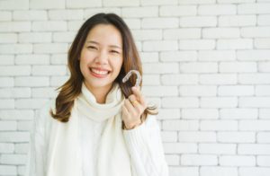 Woman holding clear aligner