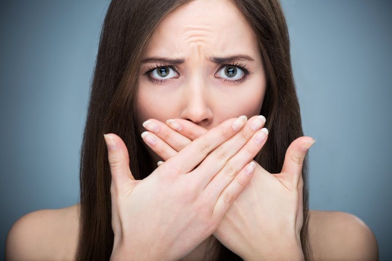 woman hiding her smile