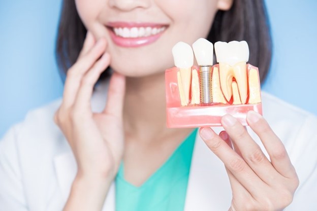 patient holding dental implant model