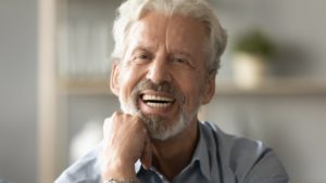 a man enjoying his complete smile with dentures