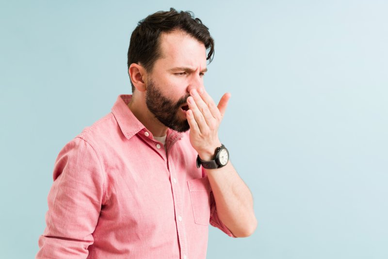 A man suffering from bad coffee breath