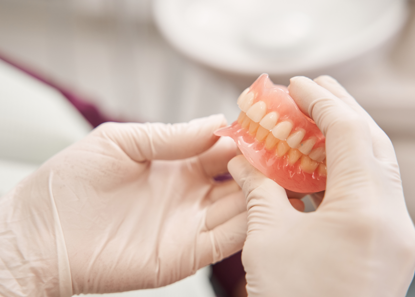 Dentist holding dentures