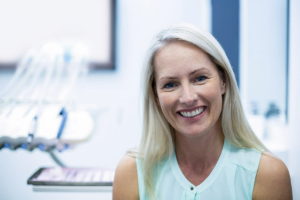 Older woman in dental office smiling